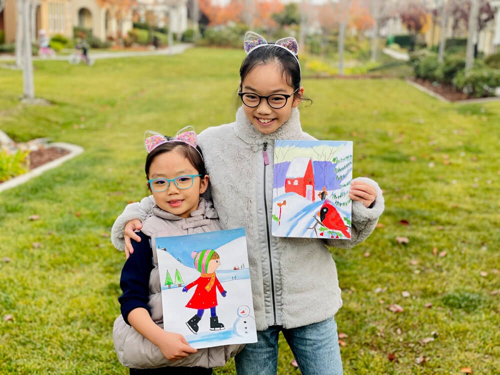 Abigail and her sister Zoe with their winter artwork at Nimmy's Art online classes located in Katy, Texas