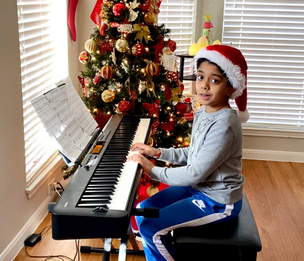 Aditya playing the Christmas song on piano