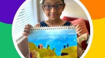 Krupa in the artists spotlight holding her painting