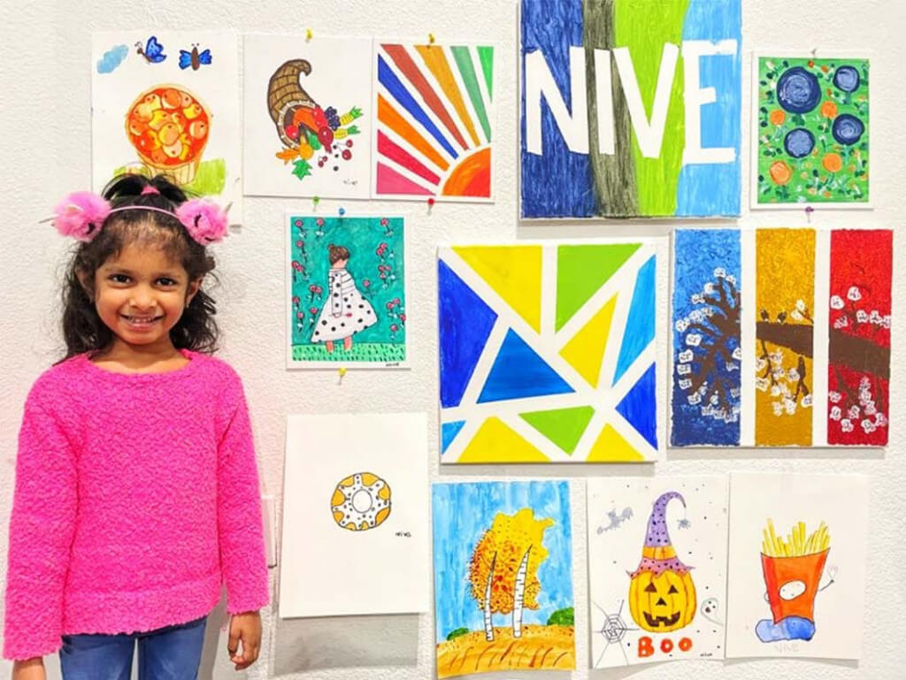 Niveditha with all her artworks completed at Nimmy's Art
