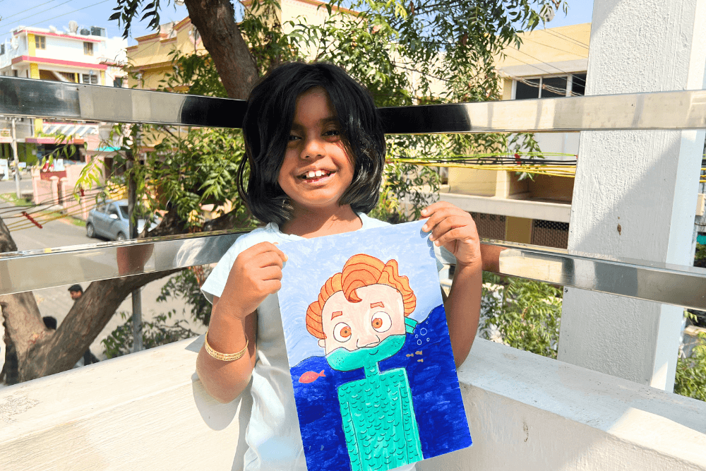 A young artist proudly holding her acrylic masterpiece – Portrait of Luca. Immerse yourself in the enchanting creation inspired by the 2021 American animated coming-of-age fantasy film produced by Walt Disney, and witness the talent nurtured in Nimmy's Art Online art classes.