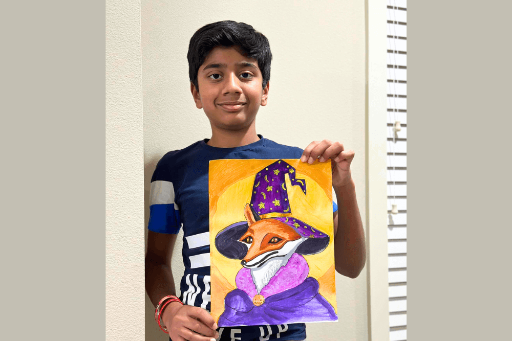 Joyful young artist proudly holds Halloween Fox Painting from Nimmy's Art Online Class