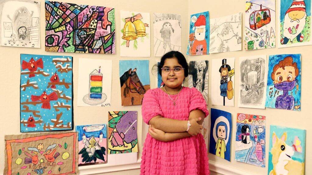 A colorful array of artwork displayed on a gallery wall, showcasing the talents of young artists from Nimmy's Art classes.