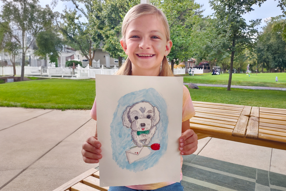 Watercolor painting of a cute dog holding roses and an envelope, created by young artist Olivia during Nimmy’s Online Art Class for Valentine’s Day.