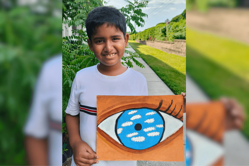 Sarthak holding his acrylic master study of The False Mirror, featuring a large eye with blue sky and white clouds inside.