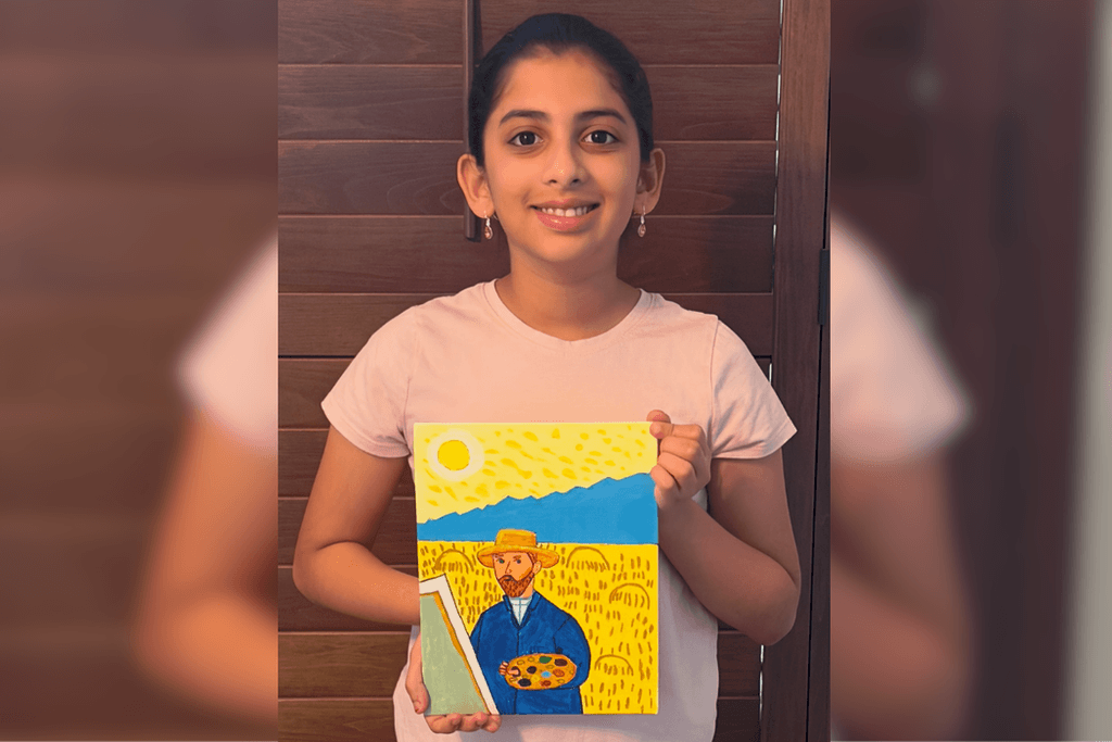 Sri Vindhya Satuluri holding her acrylic painting of Vincent van Gogh with a palette and easel against a yellow landscape.