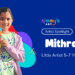 Young artist Mithra from Nimmy’s Art proudly holding her colorful fall house painting during the Artist Spotlight feature for kids ages 5–7 years.